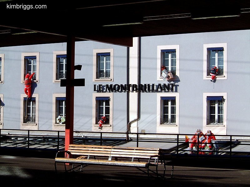 Santa Claus decorations on building exterior windows.