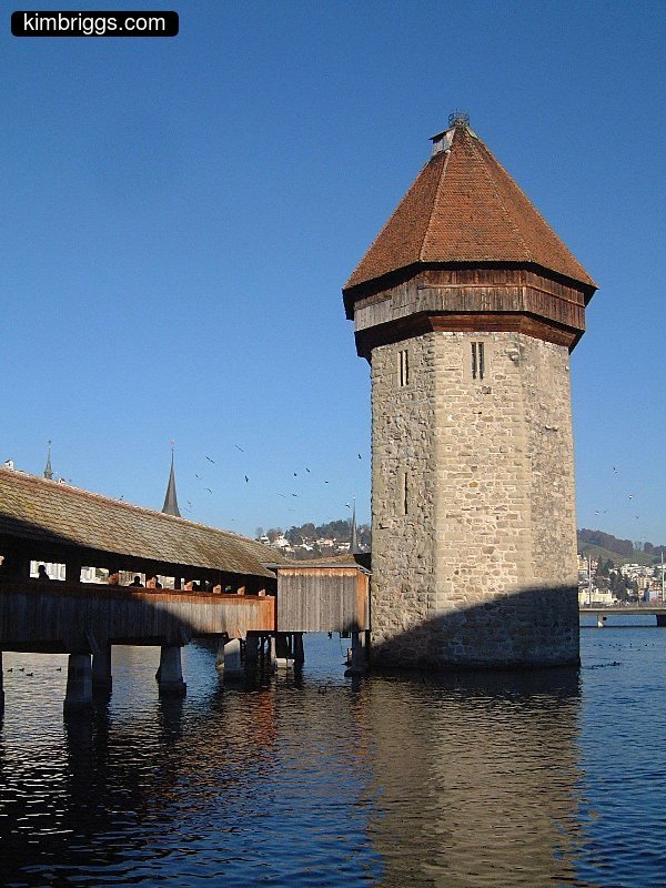 Pedestrian bridge and stone tower in Lucerne, Switzerland.