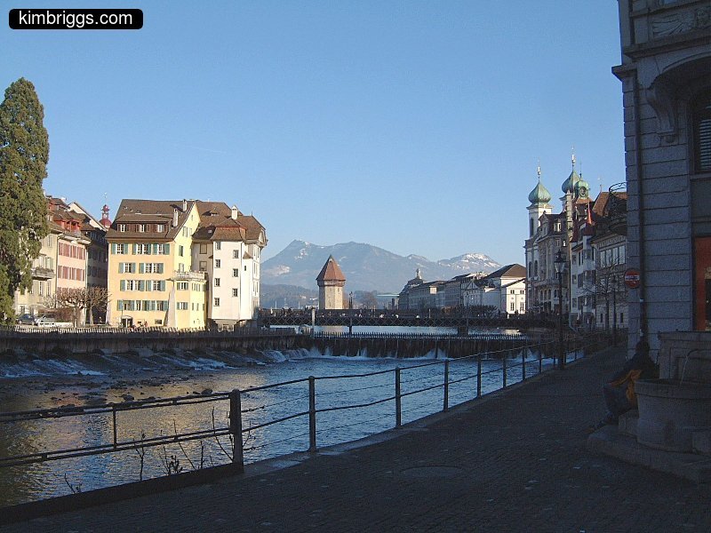 Lucerne river with Swiss Alps in background.
