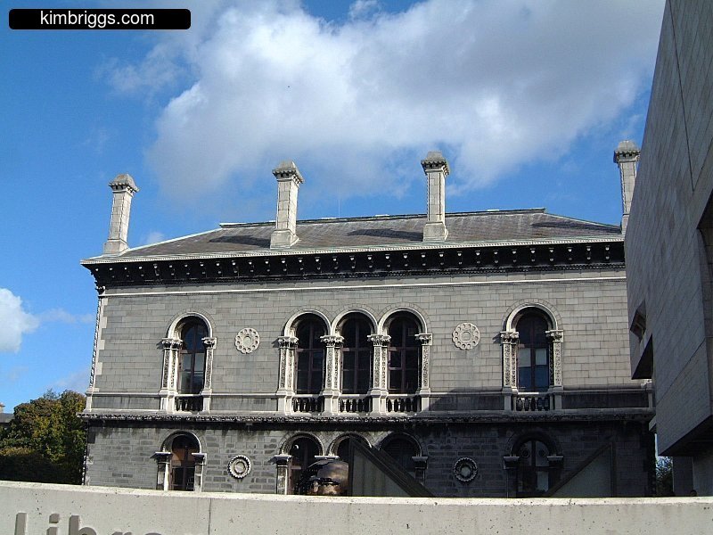 Cut stone building with arched windows.